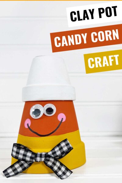 Clay pots, painted to look like candy corn, with a gingham bow and googly eyes. Text overlay says: Clay Pot Candy Corn Craft for Halloween