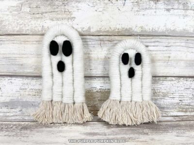 Rope that has been wrapped in white yarn, the ends frayed, and black felt eyes and mouth.