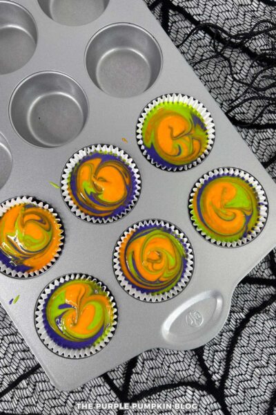 Marbled cupcake batter in cupcake pan.
