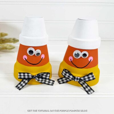 Clay pots, painted to look like candy corn, with a gingham bow and googly eyes.