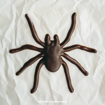 Illustrative Purposes - Milk Chocolate Spider on parchment paper.
