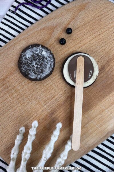Popsicle Stick Added to Oreo for Cauldron Cupcake Decoration