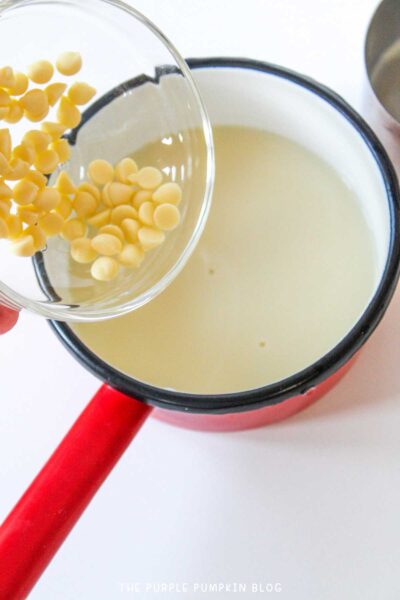 Pouring white chocolate chips into hot milk