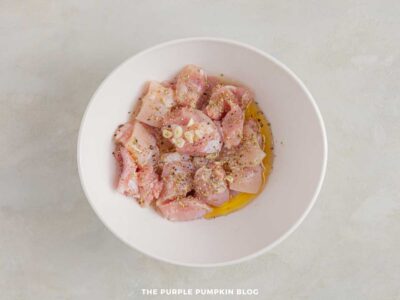Bowl of diced chicken seasoned for Greek souvlaki