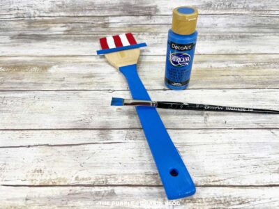 Wooden spoon craft with handle painted blue to complete Uncle Sam’s body.