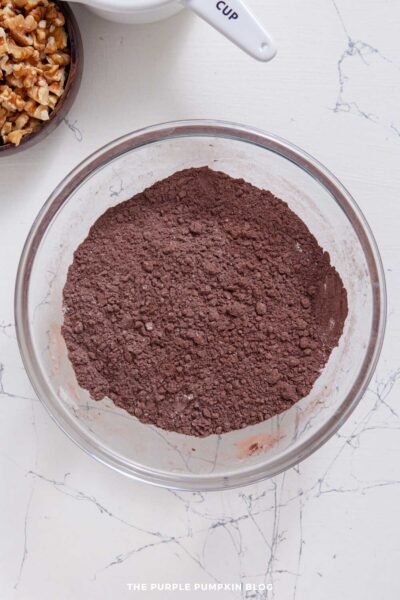 Sifted together cocoa powder, flour, and salt in a glass mixing bowl.