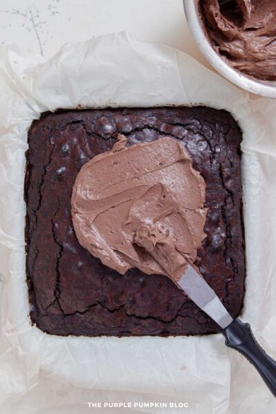 Spreading Chocolate Frosting on Top of Baked Brownies