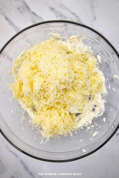 Adding Grated Cheese to Bowl