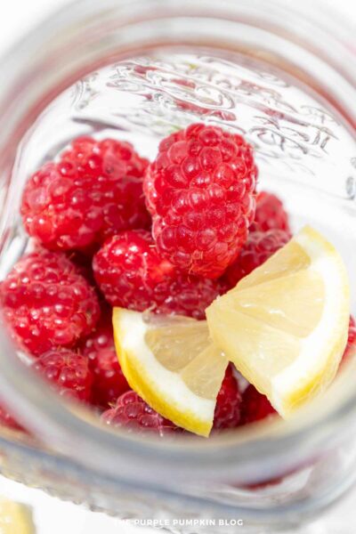Raspberries and Lemon in Glass for Muddling
