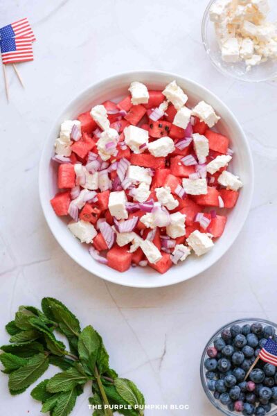 Red Onion Added to Bowl of Watermelon and Feta