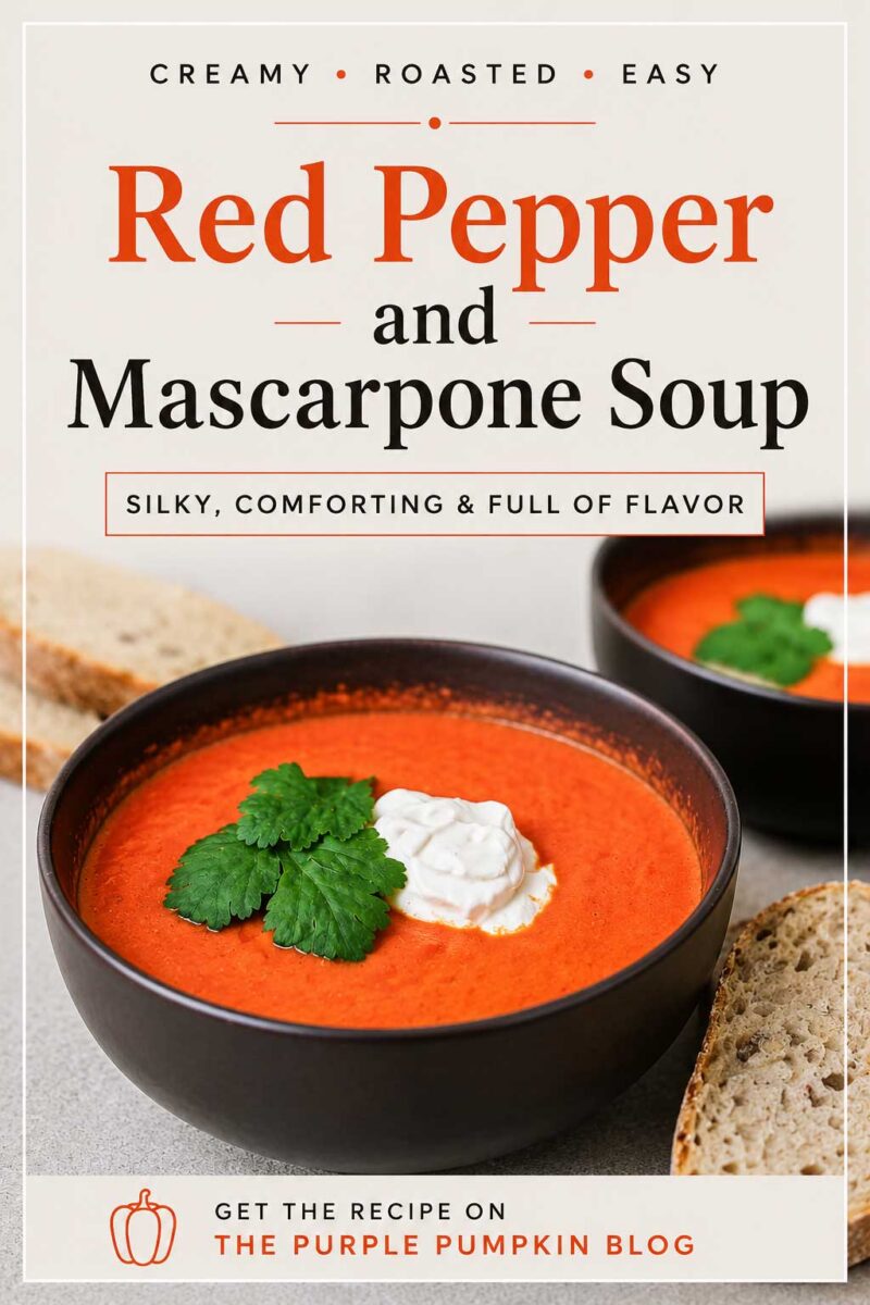 Two bowls of bright orange roasted red pepper soup topped with mascarpone cheese and parsley, served with slices of rustic seeded bread. Text overlay says: "Red Pepper and Mascarpone Soup. Silky, Comforting & Full of Flavor."
