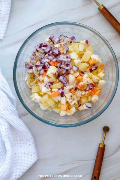 Chopped Red Onion Added to Bowl of Potatoes and Eggs