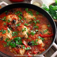 Chicken Cacciatore Spaghetti: Chicken cacciatore with chicken pieces, tomatoes, mushrooms, red peppers, black olives, and fresh parsley in a skillet.