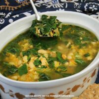 Ground Turkey Bean Soup: Ground turkey and white bean soup with spinach and shredded vegetables, served in a large serving bowl.