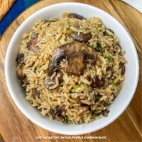 Mushroom Rice: Savory rice with sliced mushrooms, onions, and fresh herbs served in a white bowl.