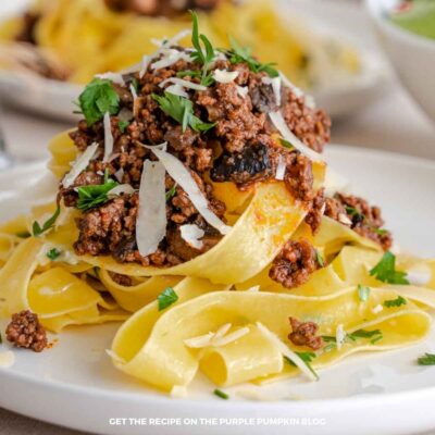 Delicious beef ragu served over fresh pasta with herbs and cheese.