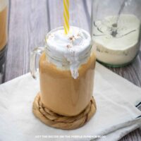Glass mug of Pumpkin Spice Protein Shake with a yellow straw