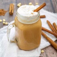 Glass mug of Pumpkin Spice White Hot Chocolate with a cinnamon